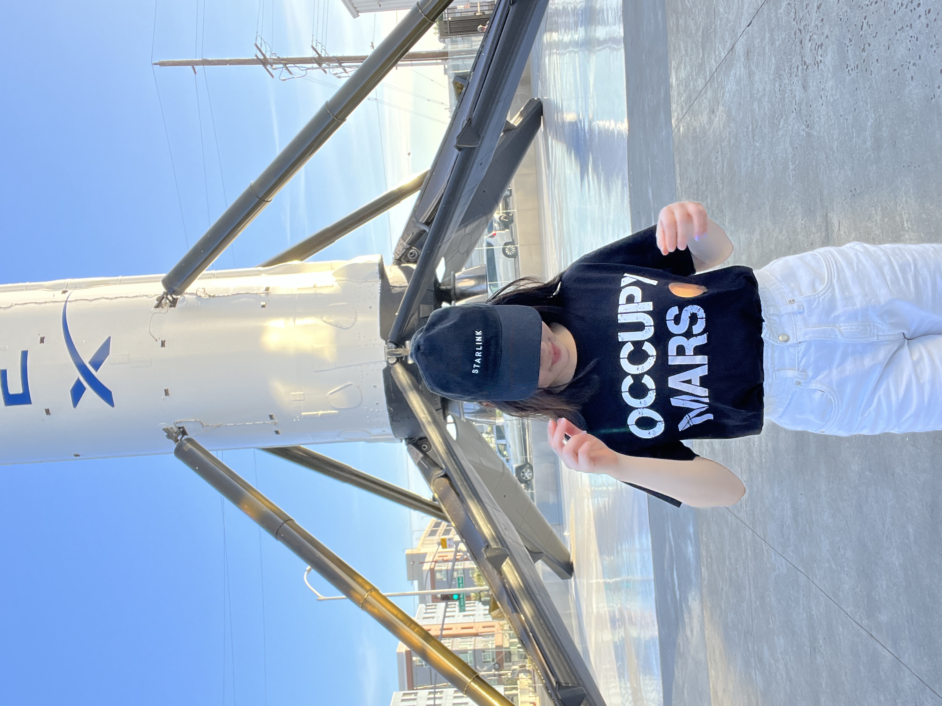 Wearing the Occupy Mars T-shirt in front of a Falcon 9 booster